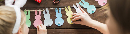 Mother and girl decorating garland